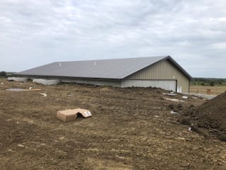 Large warehouse under construction in rural area